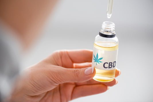 A person holding CBD Oil bottle