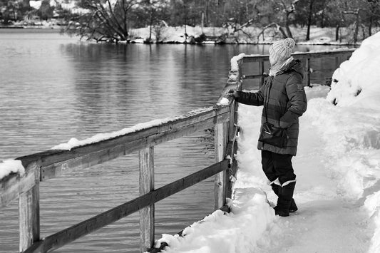 Woman dressed for winter by water